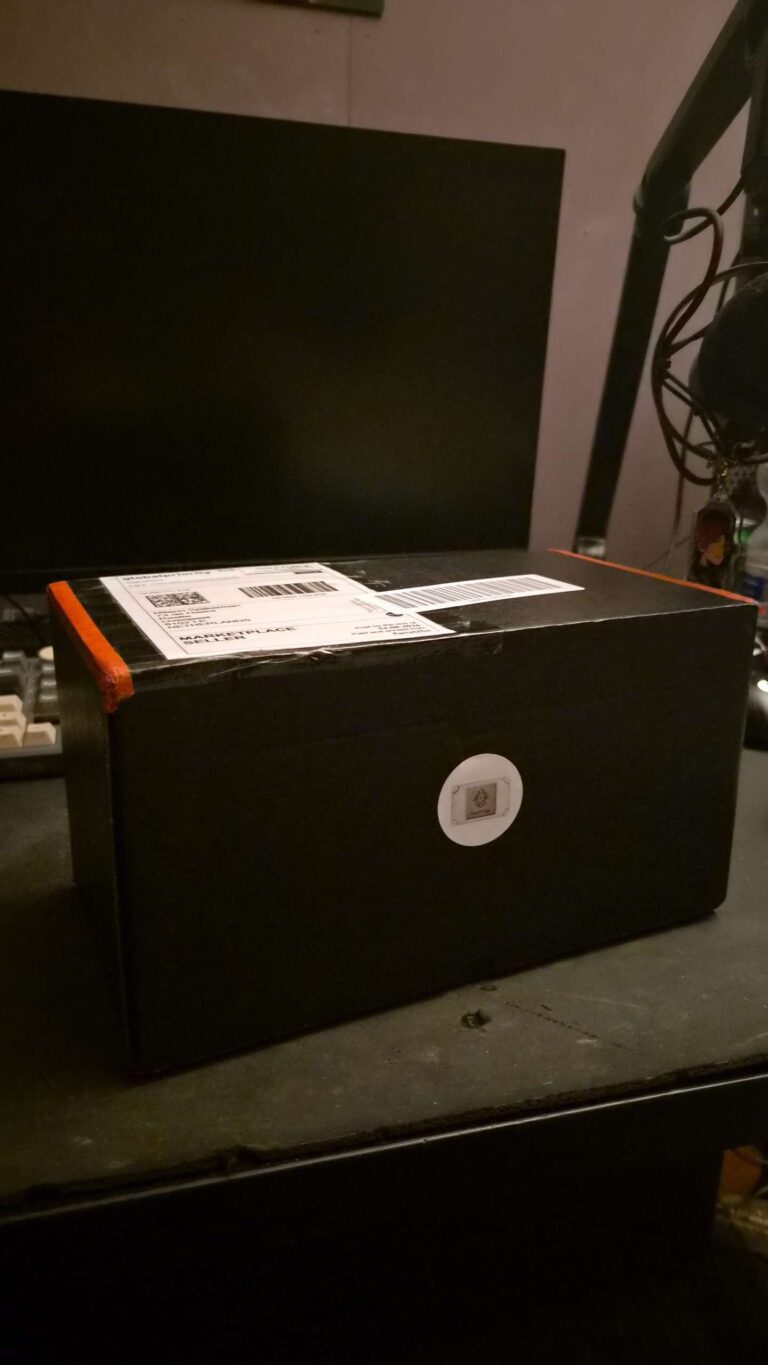 Unboxing a 3D printed Gustav cosplay arm package freshly delivered in its shipping box.